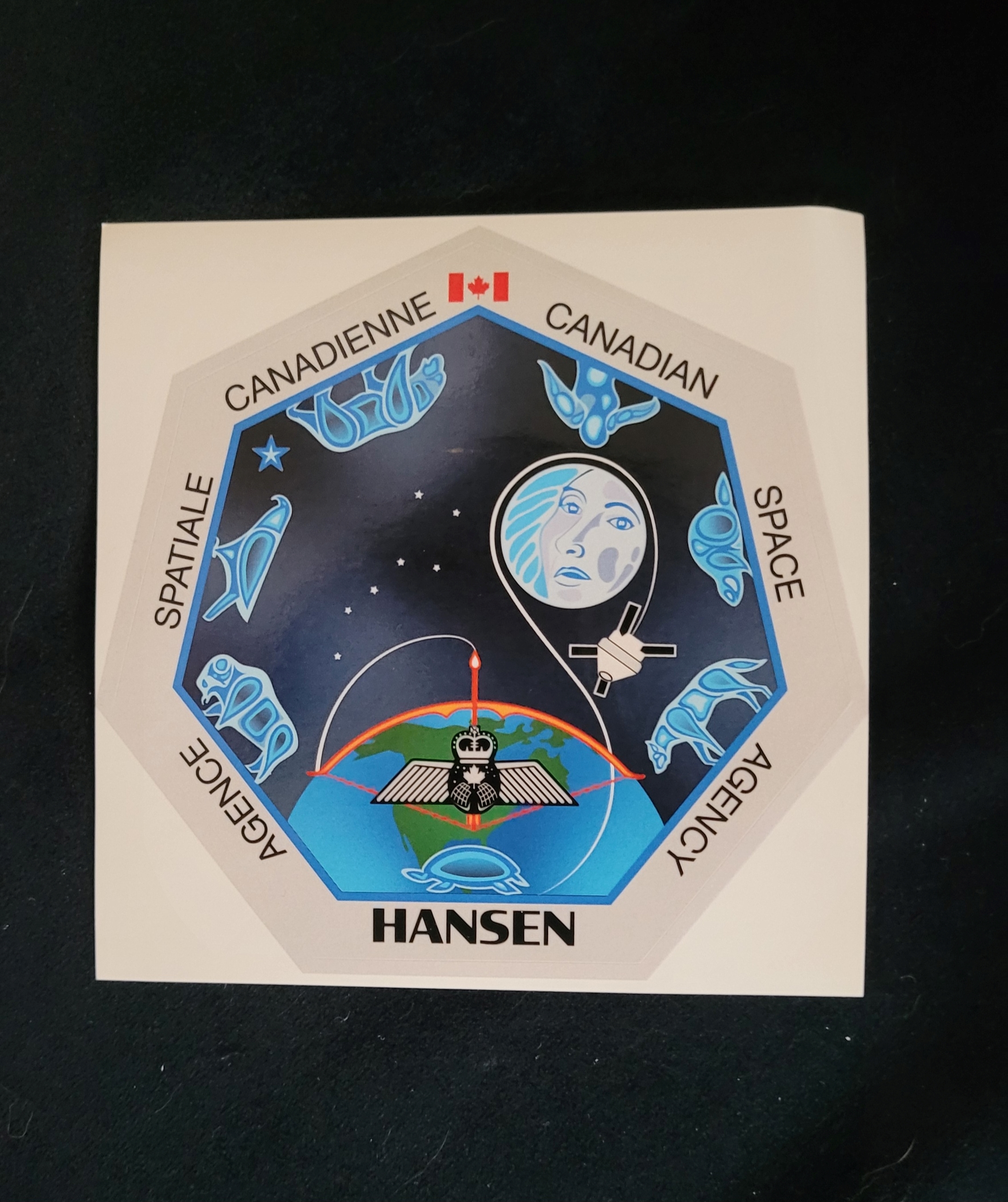 A close up of a sticker representing the special personal patch Hansen will be wearing later this fall during the Artemis II Mission.   by Kerry Benjoe