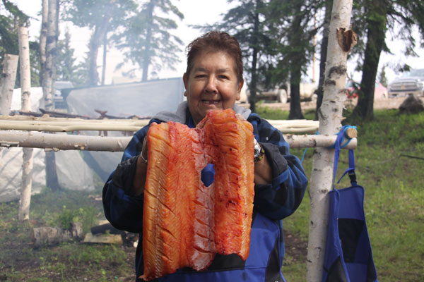Annie Natomagan shows off the trout she just filleted. The cooks and the smoker were going steady during the Elders Gathering, feeding everyone amazing fresh fish, moose and soups and, of course, bannock.