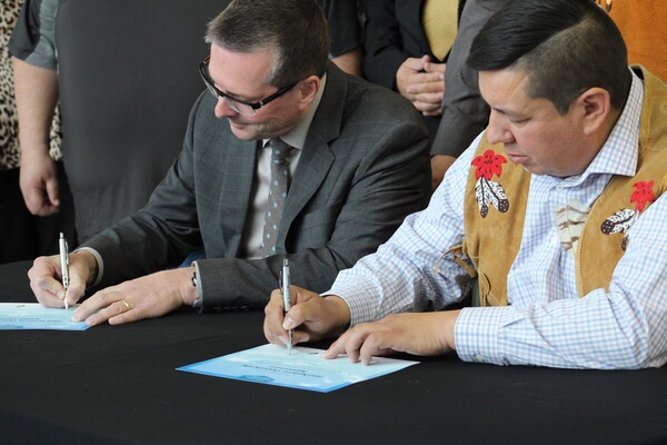 SaskPower President and CEO Mike Marsh and FNPA CEO Guy Lonechild sign the First Nations Opportunity Agreement.